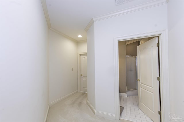 hallway with ornamental molding and light carpet