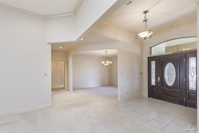 entryway with ornamental molding, light colored carpet, and an inviting chandelier