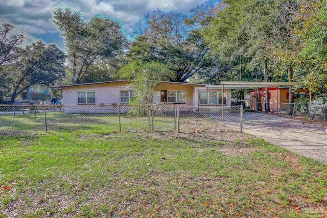 ranch-style house with a carport and a front yard