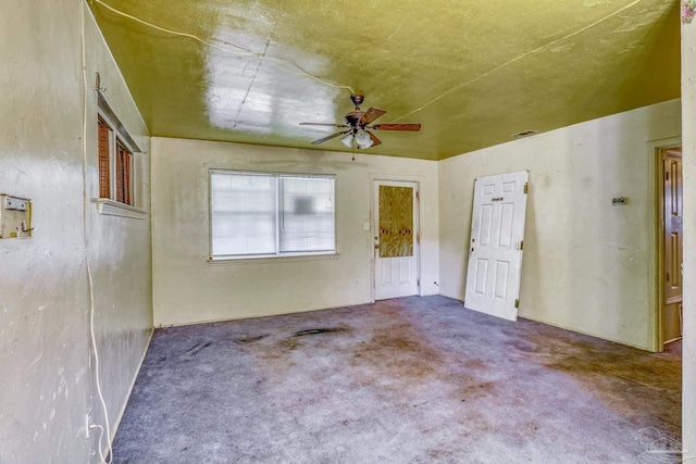 carpeted spare room with ceiling fan