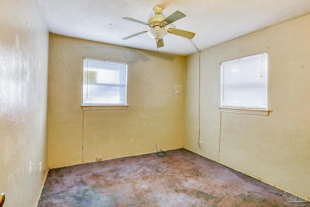 carpeted spare room featuring ceiling fan