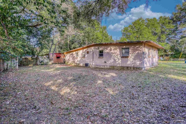 view of side of home with central AC