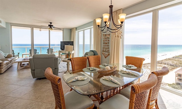 tiled dining room featuring ceiling fan with notable chandelier and plenty of natural light