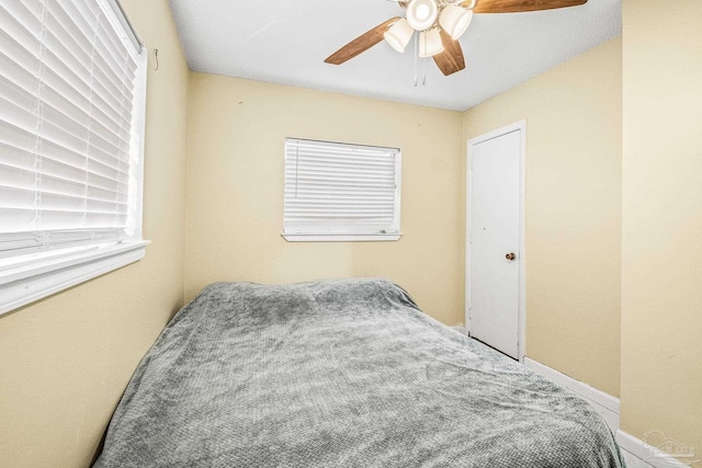 bedroom with ceiling fan and carpet floors