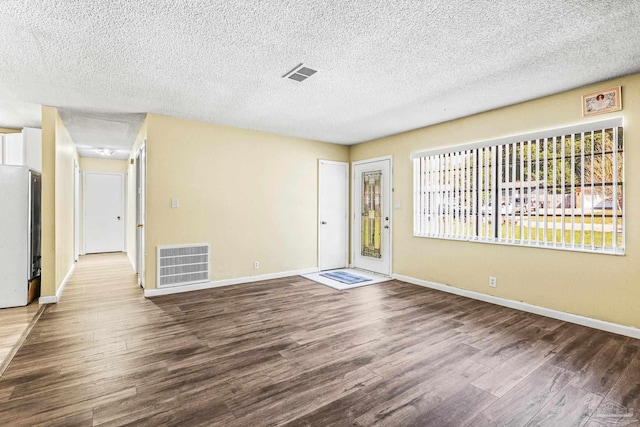 interior space with hardwood / wood-style floors and a textured ceiling