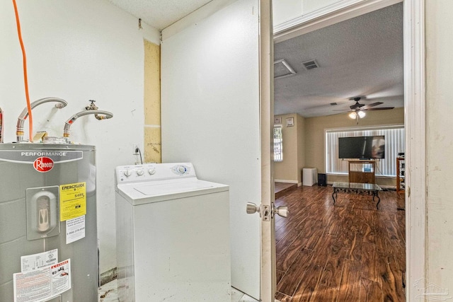 washroom featuring ceiling fan, wood-type flooring, a textured ceiling, washer / clothes dryer, and water heater