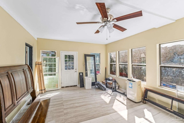 interior space featuring ceiling fan and a healthy amount of sunlight