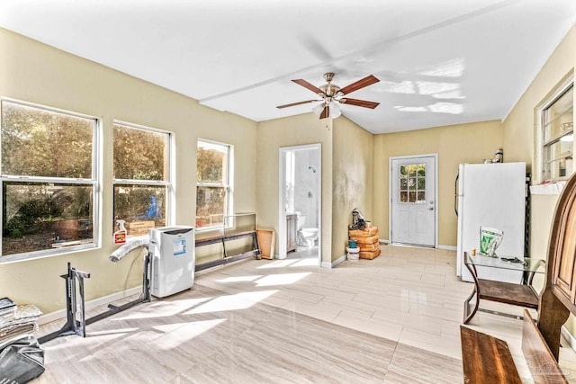 sunroom featuring ceiling fan