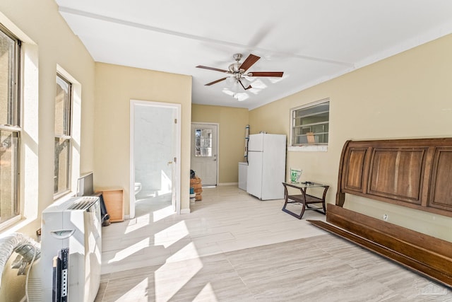 sitting room featuring light wood-type flooring, a healthy amount of sunlight, and ceiling fan