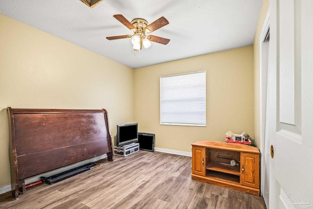 interior space with ceiling fan and hardwood / wood-style flooring