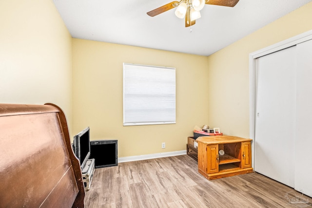 bedroom with a closet, light wood-type flooring, and ceiling fan