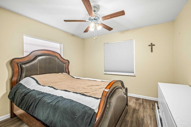 bedroom with ceiling fan and dark wood-type flooring