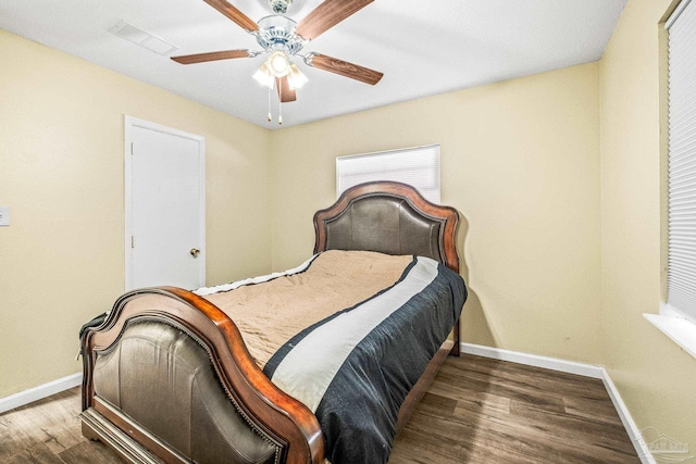 bedroom featuring ceiling fan and dark hardwood / wood-style floors