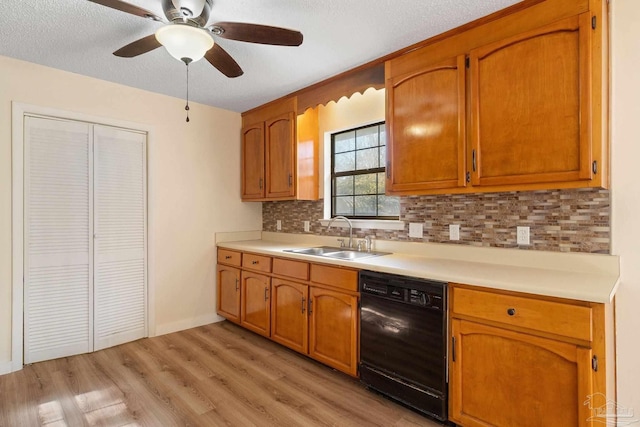 kitchen with sink, ceiling fan, decorative backsplash, black dishwasher, and light hardwood / wood-style floors