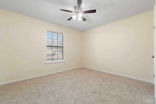 carpeted empty room featuring ceiling fan and a textured ceiling