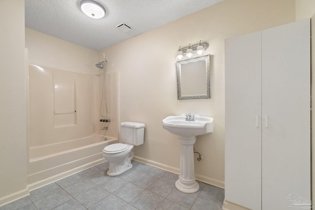 bathroom with tile patterned floors, shower / bath combination, a textured ceiling, and toilet