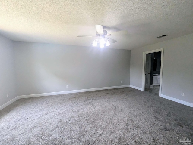 carpeted empty room featuring a textured ceiling and ceiling fan