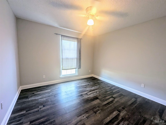 empty room featuring a textured ceiling, ceiling fan, and dark wood-type flooring