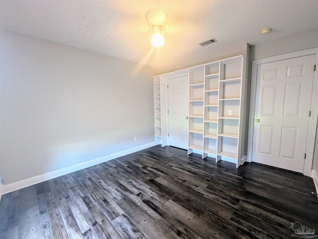 unfurnished bedroom with dark hardwood / wood-style floors