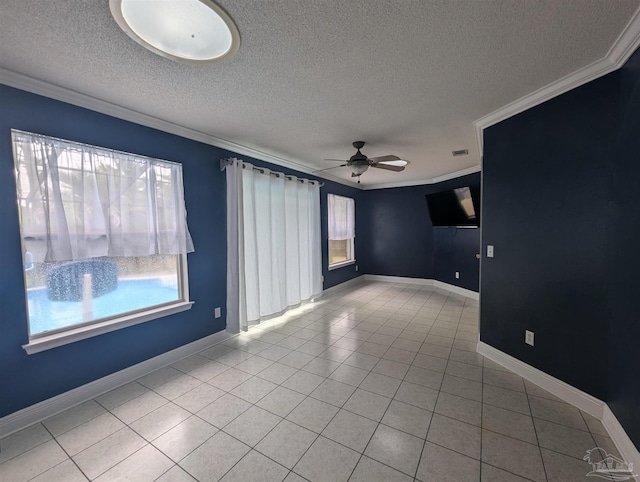 spare room with light tile patterned flooring, a textured ceiling, ornamental molding, and ceiling fan