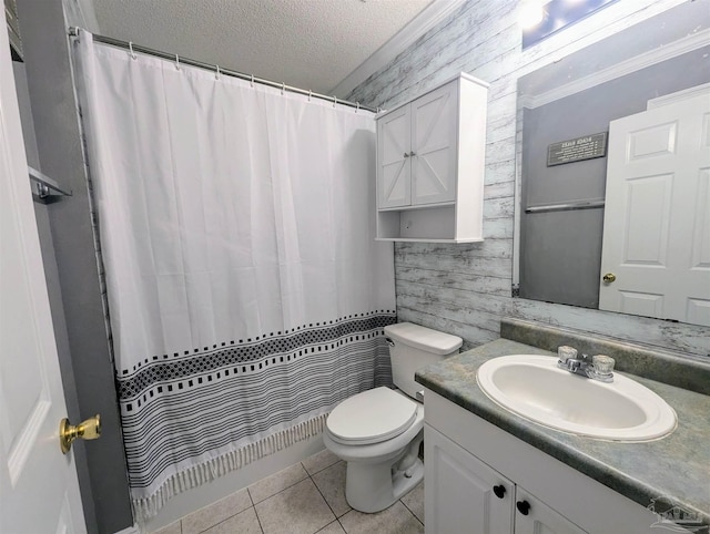 bathroom with wooden walls, a textured ceiling, toilet, vanity, and tile patterned floors