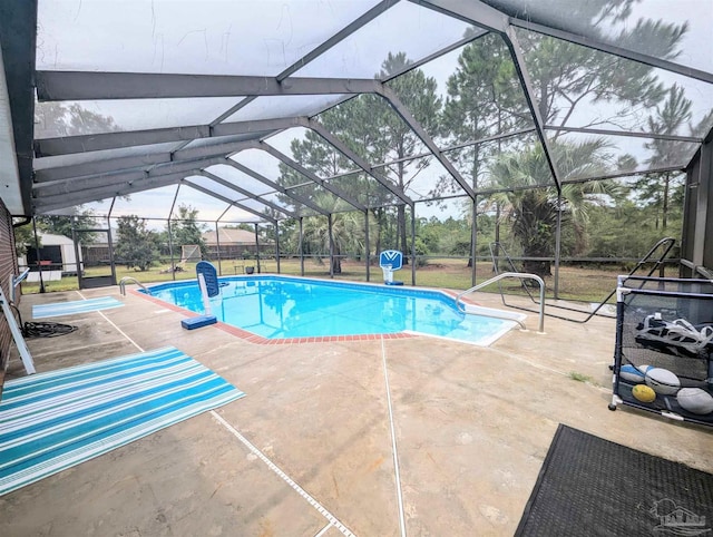 view of swimming pool with glass enclosure and a patio area