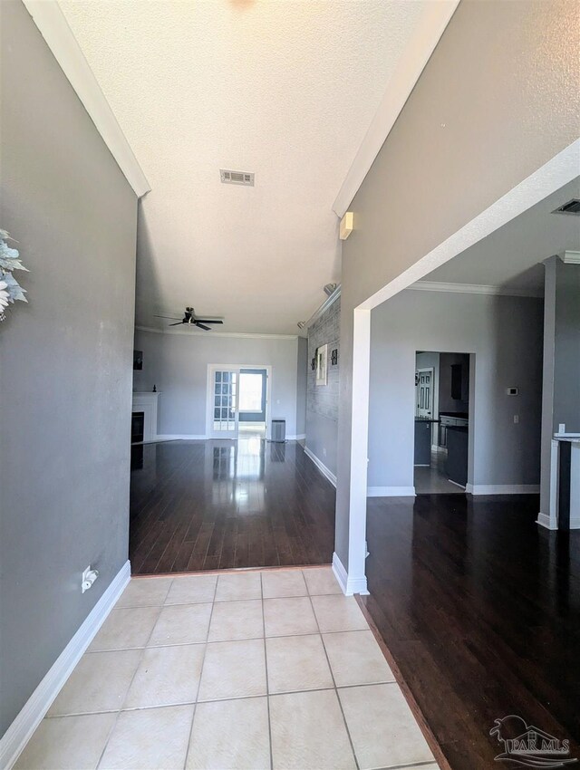 corridor featuring light hardwood / wood-style flooring and a textured ceiling