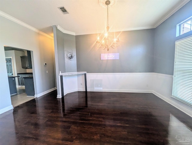 unfurnished dining area featuring ornamental molding, a textured ceiling, dark hardwood / wood-style floors, and a chandelier