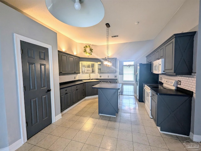 kitchen with gray cabinets, tasteful backsplash, sink, range with electric stovetop, and a center island