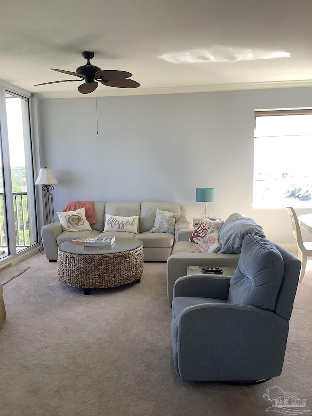 carpeted living room with ceiling fan