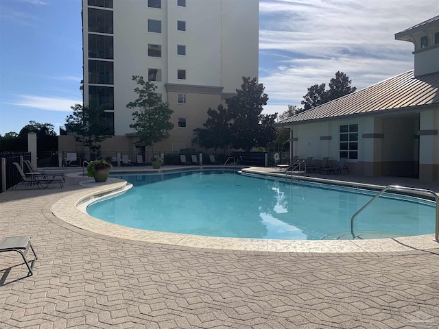 view of swimming pool with a patio