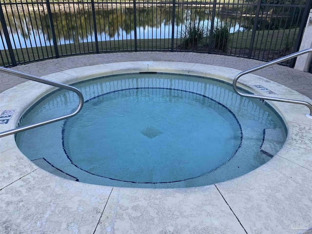 view of swimming pool featuring a water view