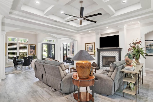 8780 Spider Lily Way, Pensacola, FL 32526 - living area featuring arched walkways, decorative columns, a towering ceiling, and a fireplace