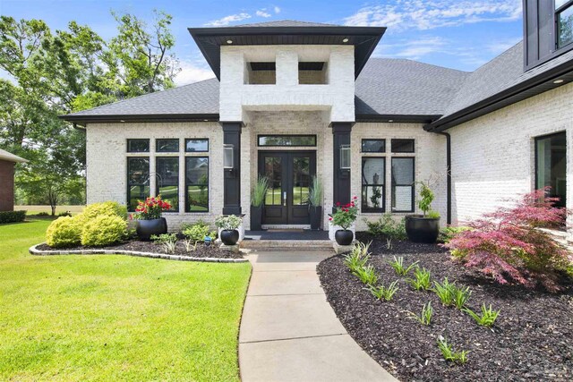 8780 Spider Lily Way, Pensacola, FL 32526 - doorway to property with french doors, a shingled roof, a yard, and brick siding