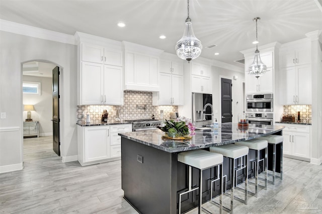 8780 Spider Lily Way, Pensacola, FL 32526 - kitchen with a kitchen breakfast bar, recessed lighting, tasteful backsplash, arched walkways, and stainless steel appliances