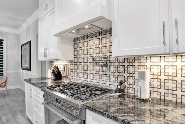 8780 Spider Lily Way, Pensacola, FL 32526 - kitchen with white cabinetry, decorative backsplash, stainless steel gas range oven, and range hood