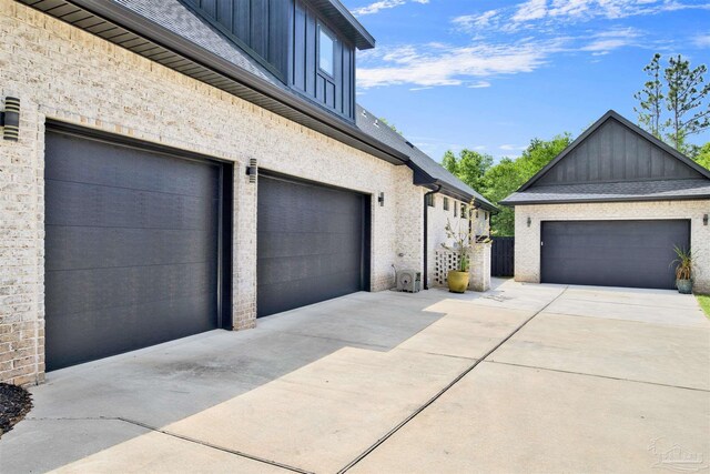 8780 Spider Lily Way, Pensacola, FL 32526 - view of home's exterior featuring a garage, board and batten siding, and driveway