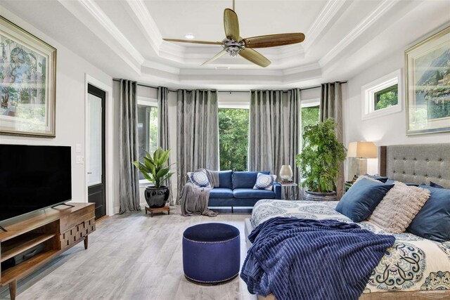8780 Spider Lily Way, Pensacola, FL 32526 - bedroom with ornamental molding, ceiling fan, wood finished floors, and a tray ceiling