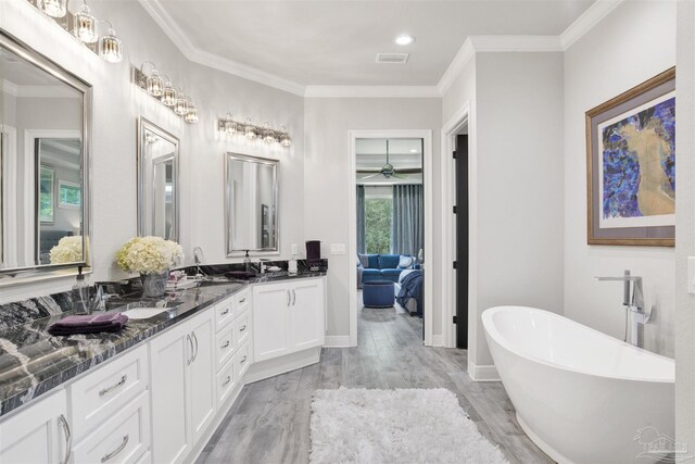 8780 Spider Lily Way, Pensacola, FL 32526 - full bathroom featuring a sink, double vanity, wood finished floors, visible vents, and a soaking tub