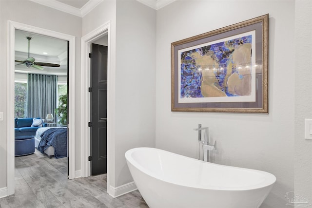 8780 Spider Lily Way, Pensacola, FL 32526 - ensuite bathroom featuring a ceiling fan, wood finished floors, ornamental molding, a soaking tub, and ensuite bath