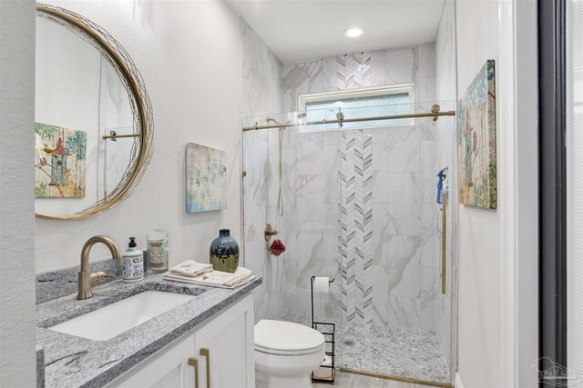8780 Spider Lily Way, Pensacola, FL 32526 - full bathroom featuring a marble finish shower, a textured wall, vanity, and toilet
