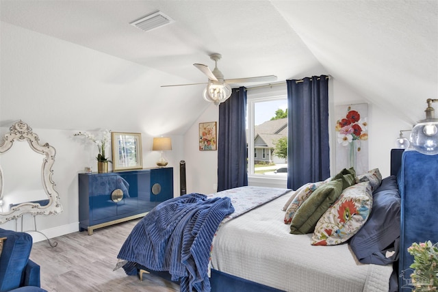 8780 Spider Lily Way, Pensacola, FL 32526 - bedroom with a ceiling fan, visible vents, vaulted ceiling, wood finished floors, and baseboards