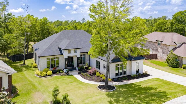 8780 Spider Lily Way, Pensacola, FL 32526 - french country style house featuring fence, driveway, and a front yard