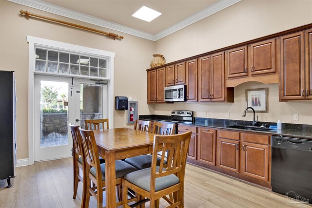 8780 Spider Lily Way, Pensacola, FL 32526 - kitchen with crown molding, brown cabinets, a sink, light wood-style flooring, and stainless steel appliances