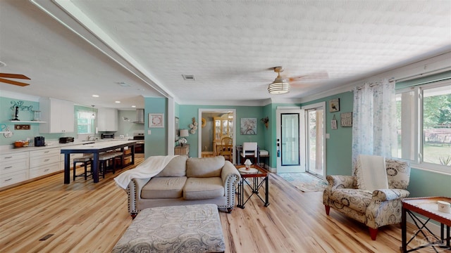 200 Talladega Trl, Pensacola, FL 32506 - living room with ceiling fan, light wood-type flooring, and ornamental molding