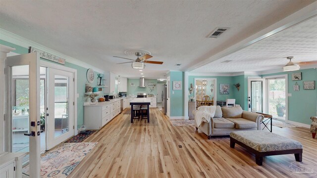 200 Talladega Trl, Pensacola, FL 32506 - living room featuring light wood-style flooring, ceiling fan, french doors, crown molding, and baseboards