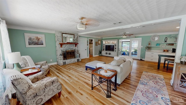 200 Talladega Trl, Pensacola, FL 32506 - living room featuring ornamental molding, baseboards, a stone fireplace, wood finished floors, and ceiling fan