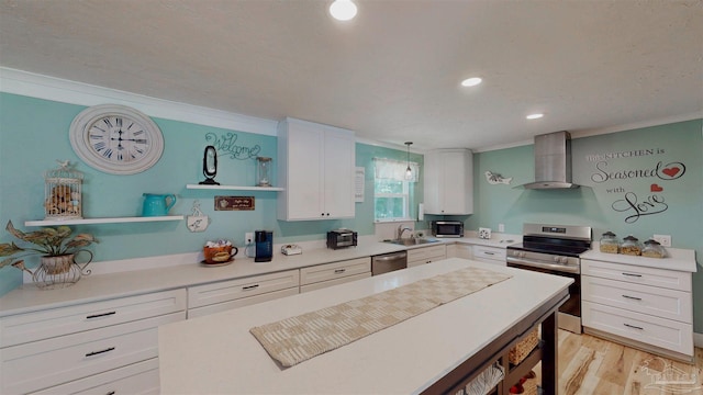 200 Talladega Trl, Pensacola, FL 32506 - kitchen featuring wall chimney range hood, appliances with stainless steel finishes, ornamental molding, a sink, and white cabinetry