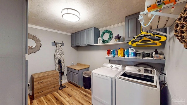 200 Talladega Trl, Pensacola, FL 32506 - laundry room with washing machine and clothes dryer, light wood-style flooring, cabinet space, a textured ceiling, and crown molding
