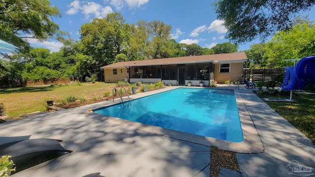 200 Talladega Trl, Pensacola, FL 32506 - view of swimming pool with a sunroom, a lawn, and a patio area